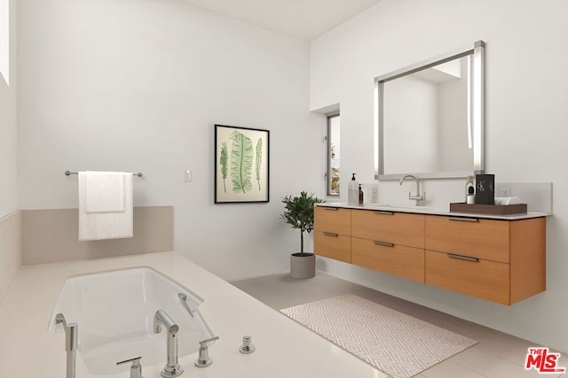 bathroom with tile patterned flooring, vanity, and a bathing tub