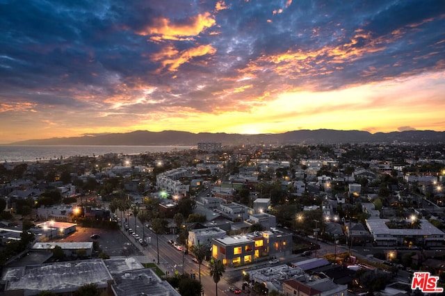 aerial view at dusk featuring a mountain view