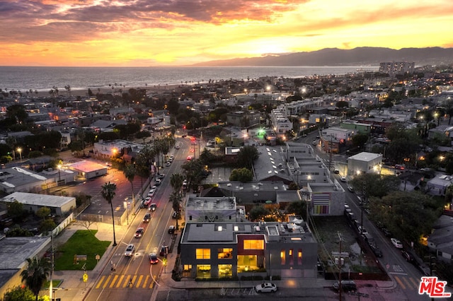 aerial view at dusk with a water view