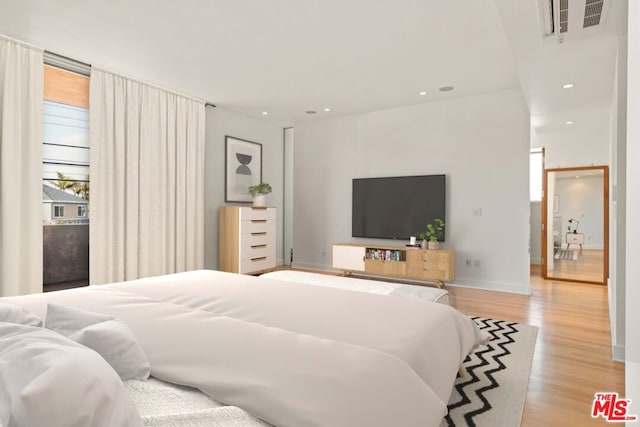 bedroom with light hardwood / wood-style floors