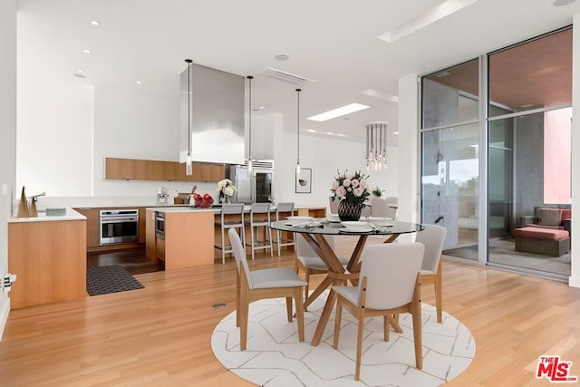 dining space with light hardwood / wood-style flooring