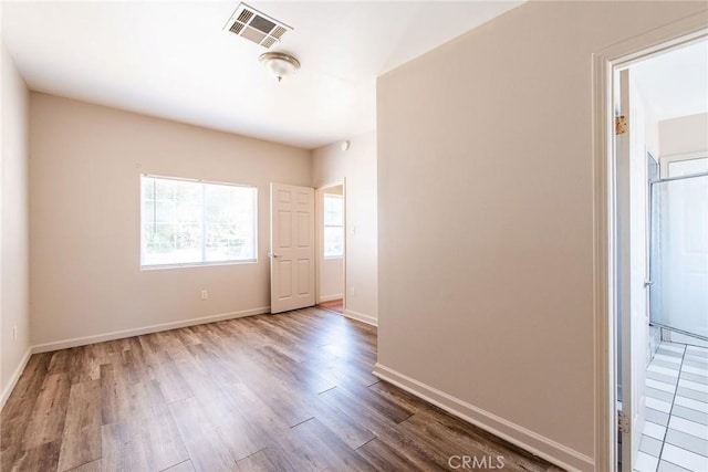 unfurnished room with hardwood / wood-style floors