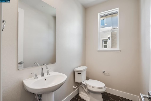 bathroom featuring tile patterned flooring, sink, and toilet