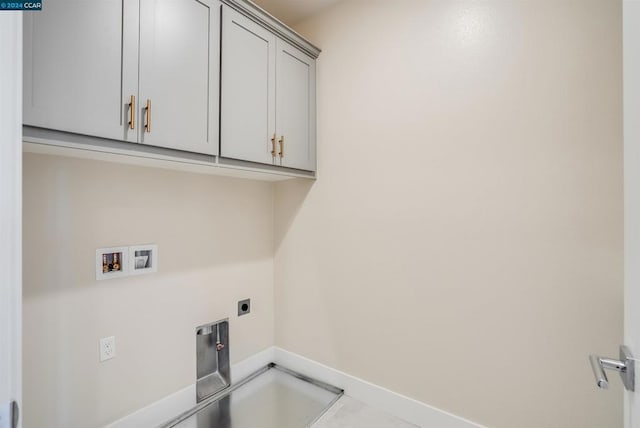 washroom with hookup for a washing machine, cabinets, and hookup for an electric dryer