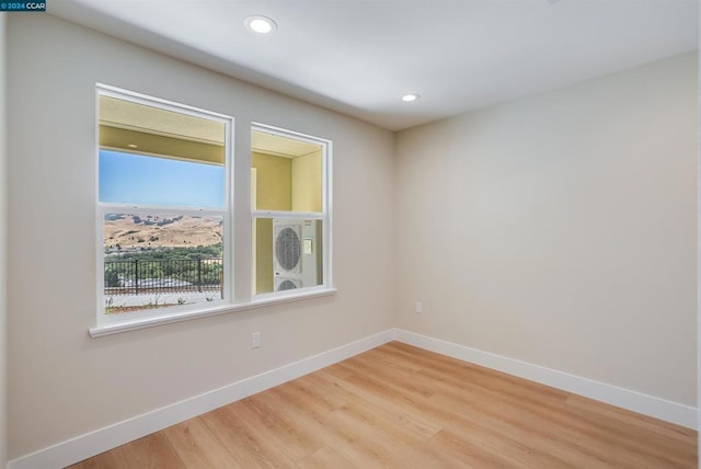 unfurnished room featuring hardwood / wood-style flooring