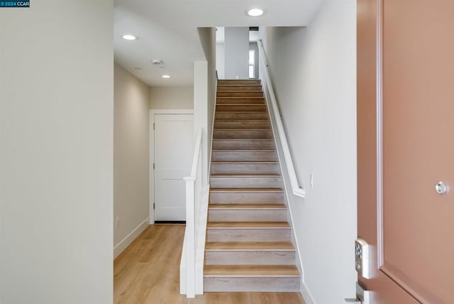 stairs featuring wood-type flooring