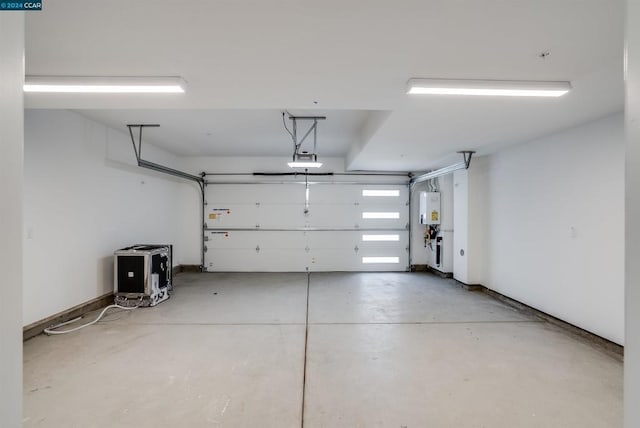 garage with water heater and a garage door opener