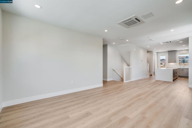 unfurnished living room with light hardwood / wood-style floors