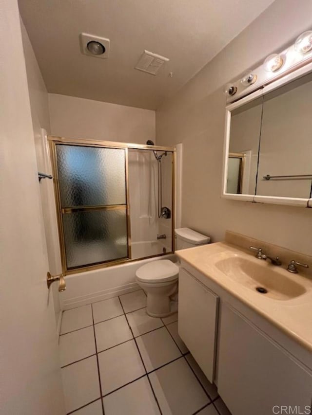 full bathroom with tile patterned floors, vanity, enclosed tub / shower combo, and toilet