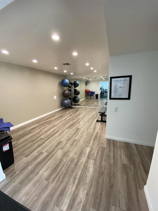 workout room with light hardwood / wood-style flooring