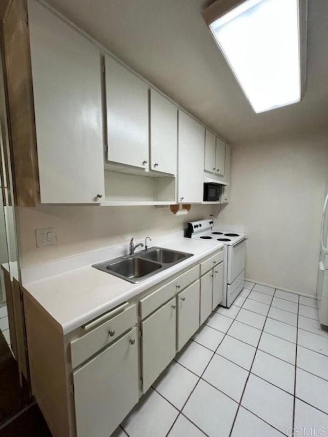 kitchen featuring electric stove, white cabinetry, sink, and light tile patterned flooring