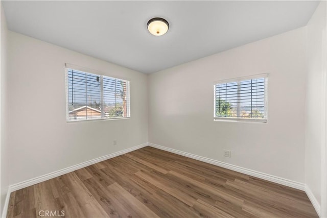 spare room with hardwood / wood-style floors