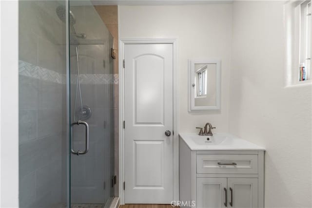 bathroom featuring vanity and an enclosed shower