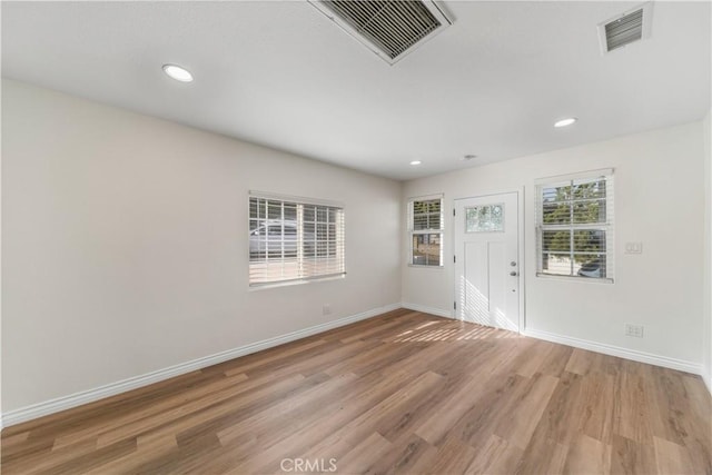 spare room featuring light hardwood / wood-style floors