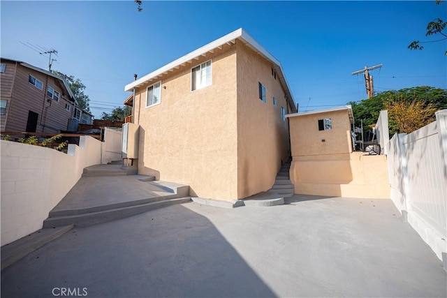 view of side of home with a patio area