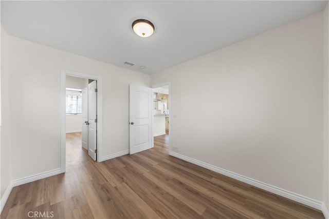 spare room with hardwood / wood-style floors