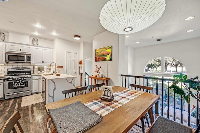 dining room with sink and hardwood / wood-style flooring