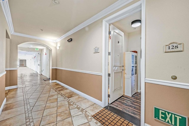 corridor featuring crown molding and light tile patterned floors