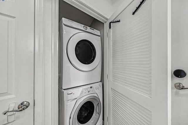 laundry room with stacked washer / drying machine