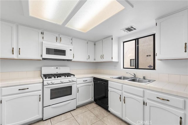 kitchen featuring white cabinetry, tile counters, sink, and white appliances