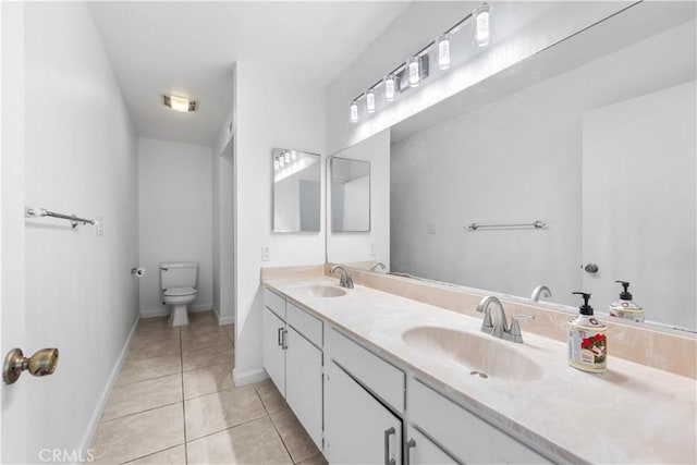 bathroom featuring toilet, vanity, and tile patterned floors