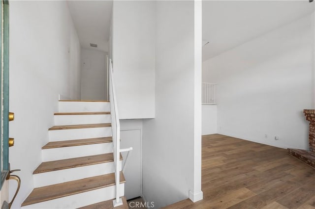 staircase featuring hardwood / wood-style flooring