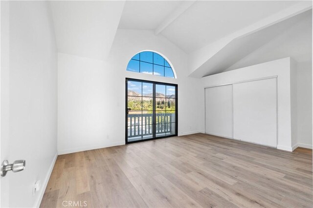 additional living space with beam ceiling, high vaulted ceiling, and light wood-type flooring