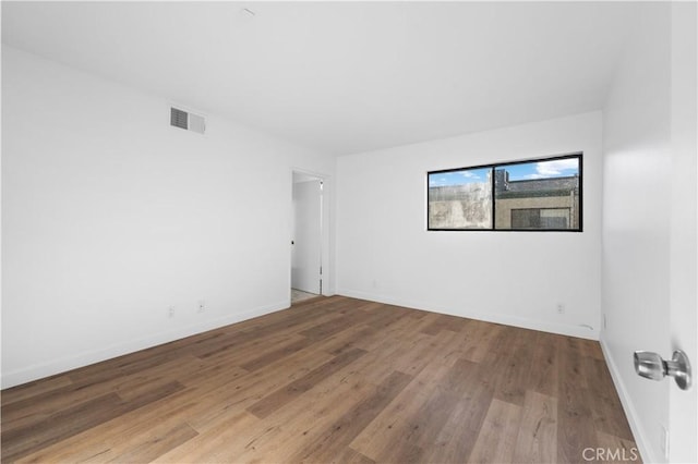 spare room with wood-type flooring