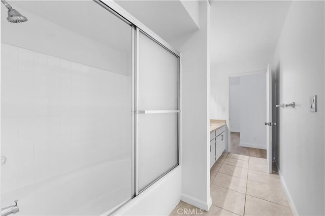 bathroom featuring combined bath / shower with glass door, vanity, and tile patterned floors