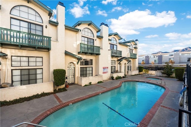 view of swimming pool featuring a patio area