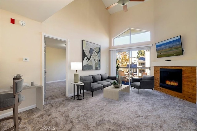 carpeted living room featuring high vaulted ceiling and ceiling fan