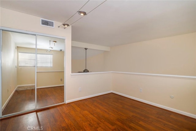 unfurnished bedroom with hardwood / wood-style floors and a closet