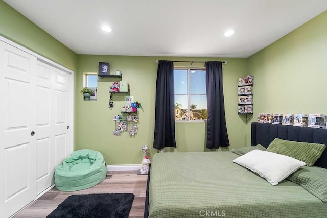 bedroom with a closet and hardwood / wood-style flooring