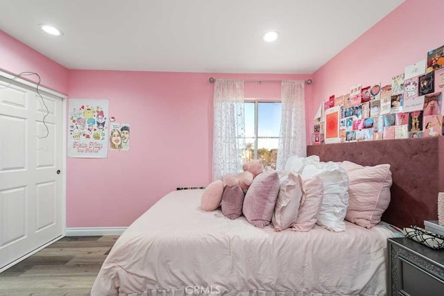 bedroom with wood-type flooring