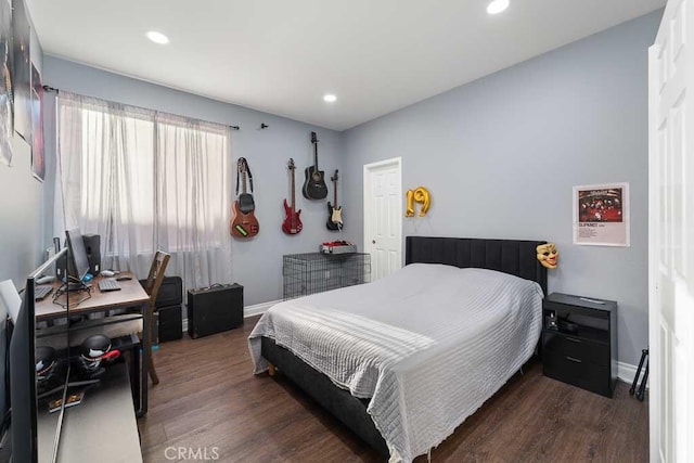 bedroom with dark hardwood / wood-style floors