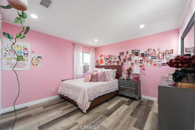 bedroom with wood-type flooring