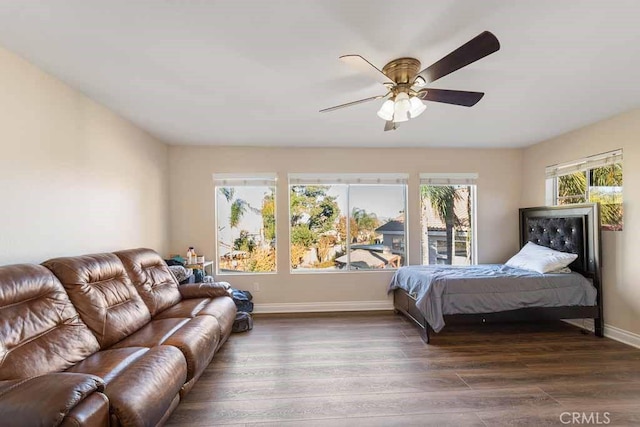 bedroom with ceiling fan and dark hardwood / wood-style floors