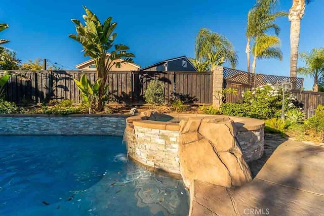 view of swimming pool featuring pool water feature