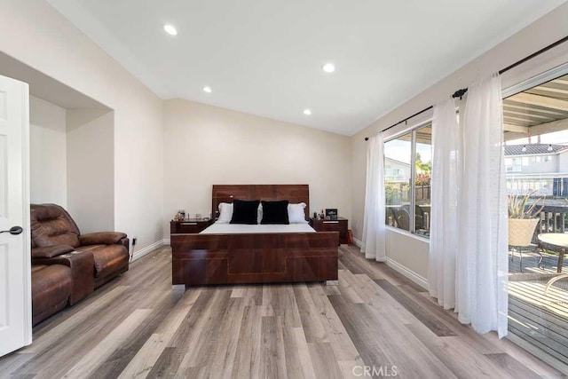 bedroom with access to outside, vaulted ceiling, and light wood-type flooring