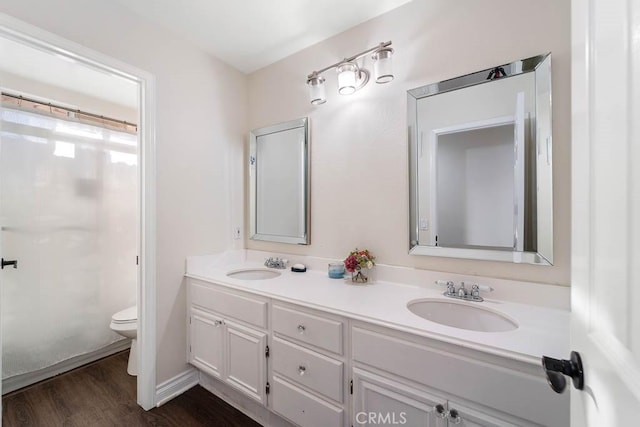 bathroom with a shower with curtain, vanity, hardwood / wood-style flooring, and toilet