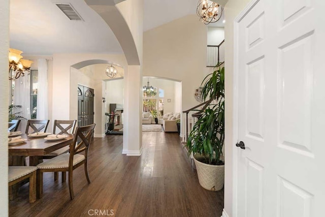 interior space featuring vaulted ceiling, a wealth of natural light, and dark wood-type flooring