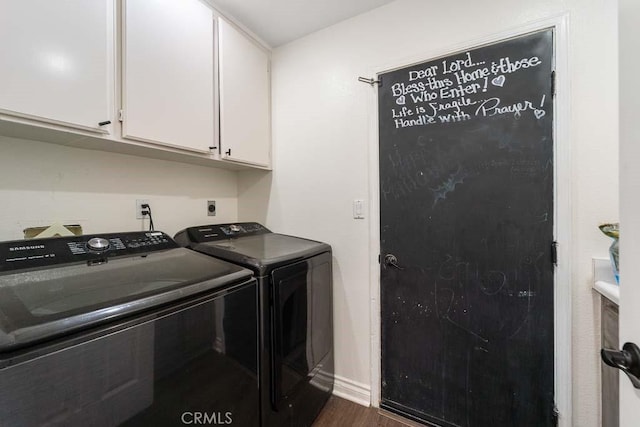 laundry room with cabinets, dark hardwood / wood-style flooring, and washer and dryer