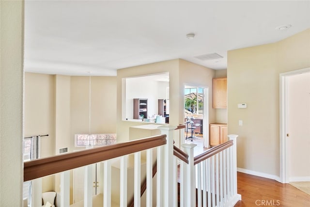 corridor with light hardwood / wood-style floors