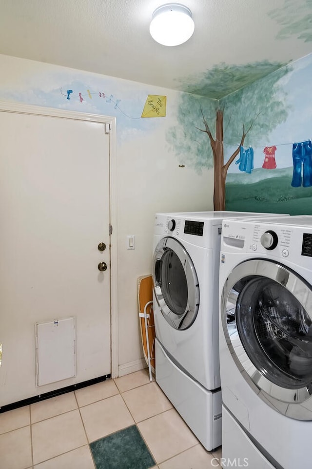 washroom with independent washer and dryer and light tile patterned floors