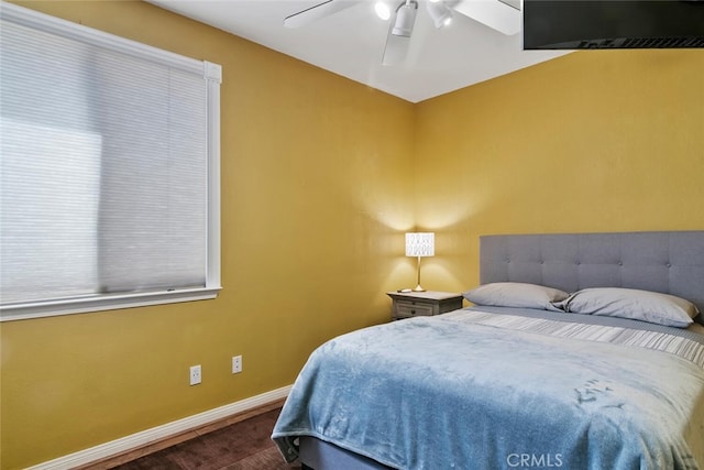 bedroom with ceiling fan and dark wood-type flooring