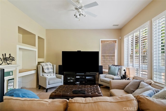 carpeted living room featuring ceiling fan