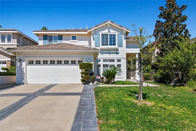 view of front of property featuring a garage and a front lawn