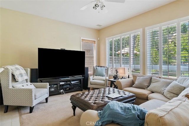 tiled living room with ceiling fan and a healthy amount of sunlight