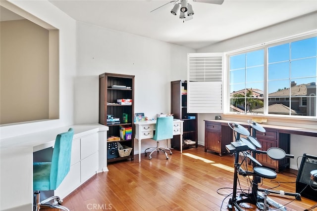 office with ceiling fan and light hardwood / wood-style flooring