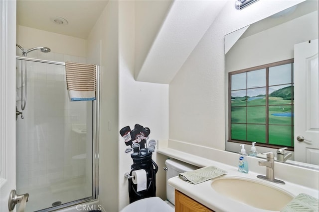 bathroom with vanity, toilet, and a shower with door